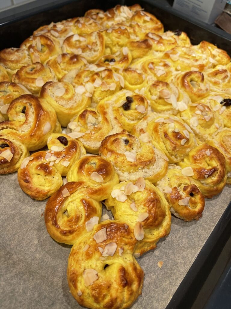 Tray of saffron buns with almond flakes
