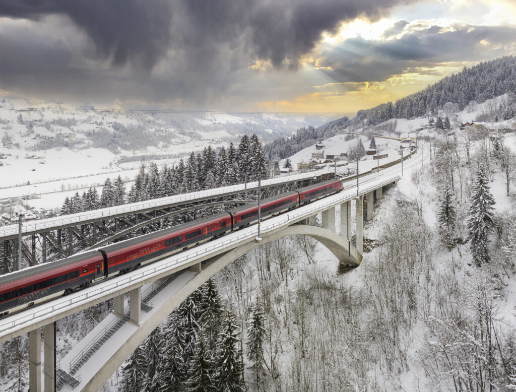 Train on bridge in snowy landscape