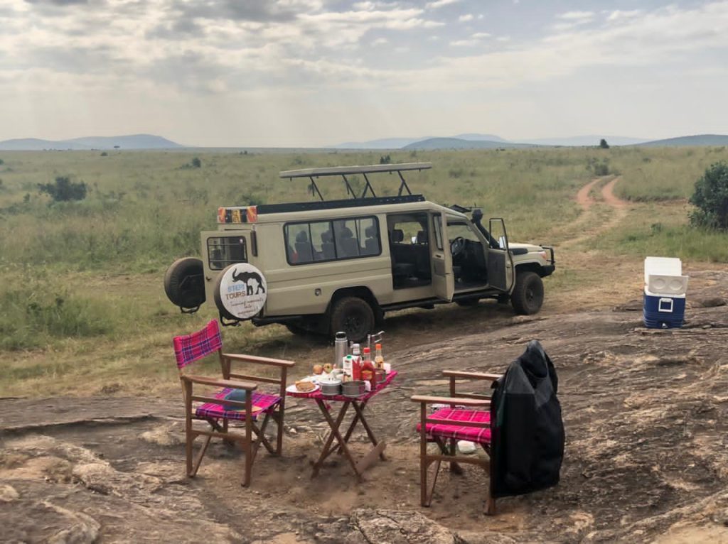 Safari car with table set up for dinner in the bush