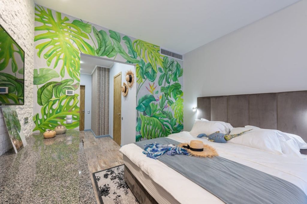 Hotel room with green leaves as wall paper