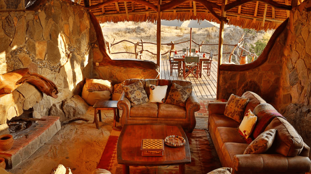 Lodge in the bush with sofas and table.