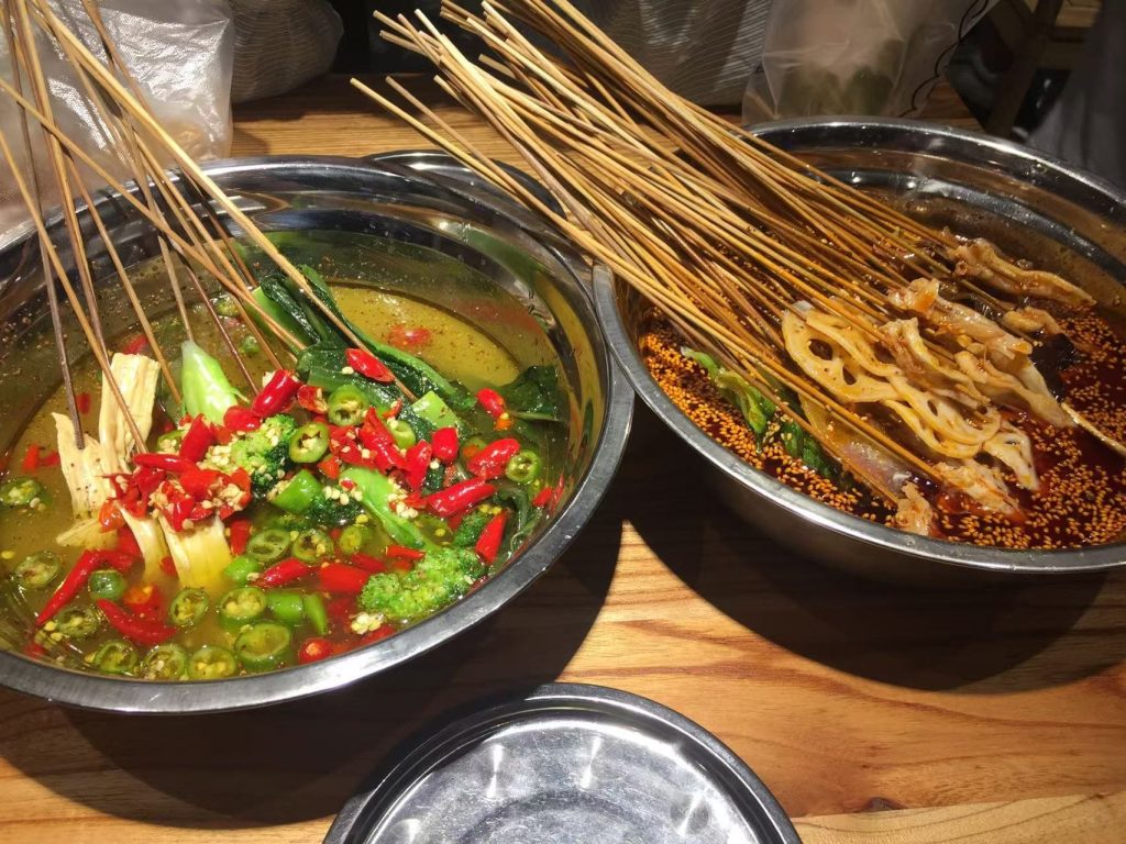 Skewered chicken in pot of soup