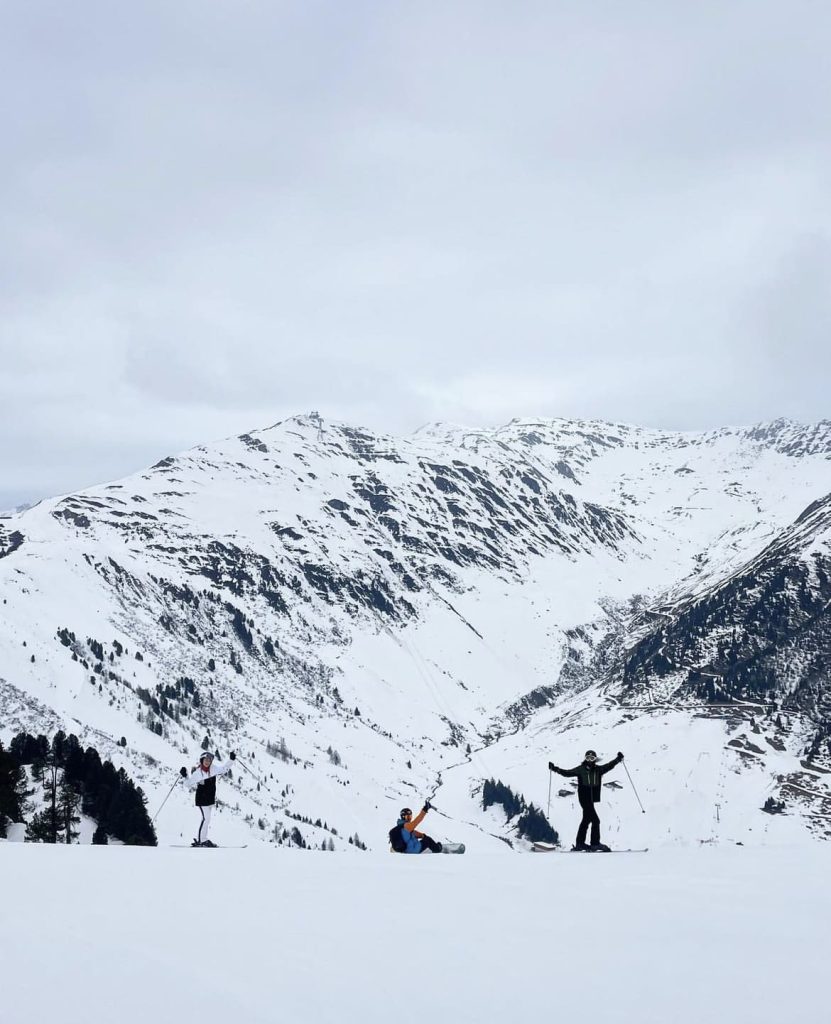 Skiers on the way down a steep slope