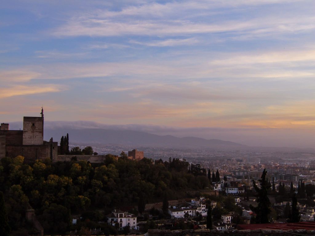 Fortress amid a forested hill overlooking a city