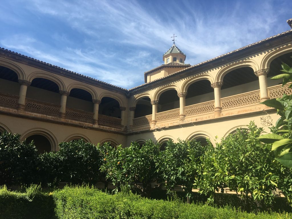 Courtyard with trees inside a two tiered monastery