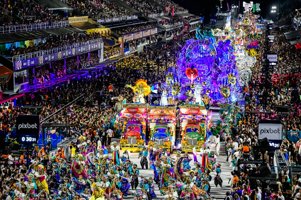 Huge and colourful parade with floats and stands with audiences on both sides