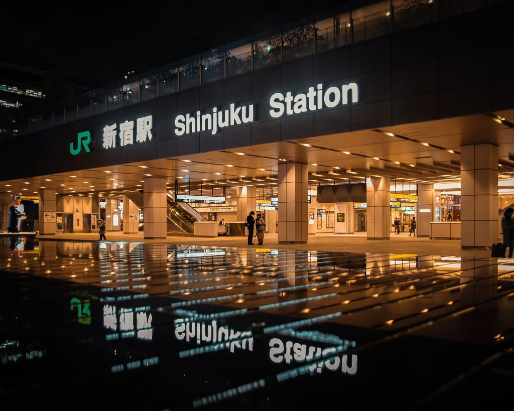 Train station platform at night with name in neon light