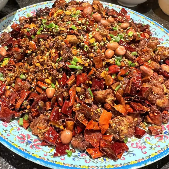 Plate of chicken and chillies mix together