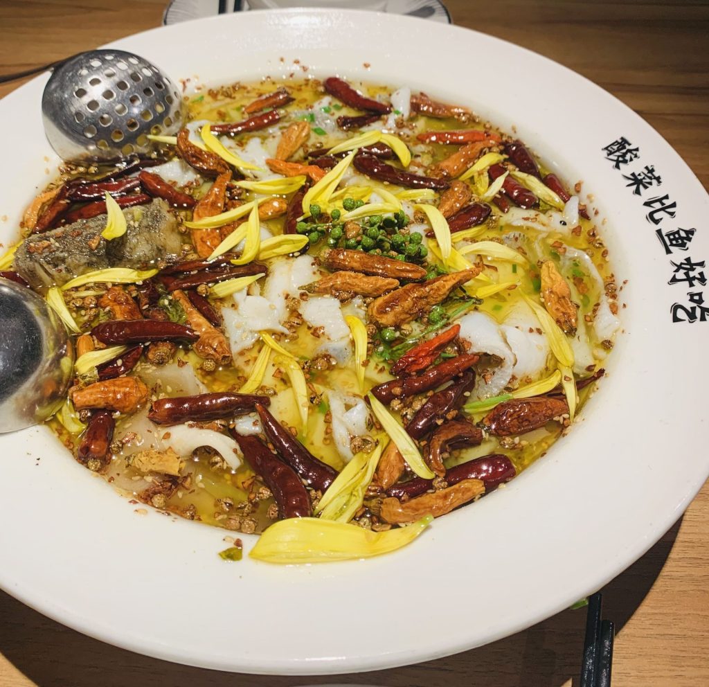Bowl of soup with fish, cabbage, chillies