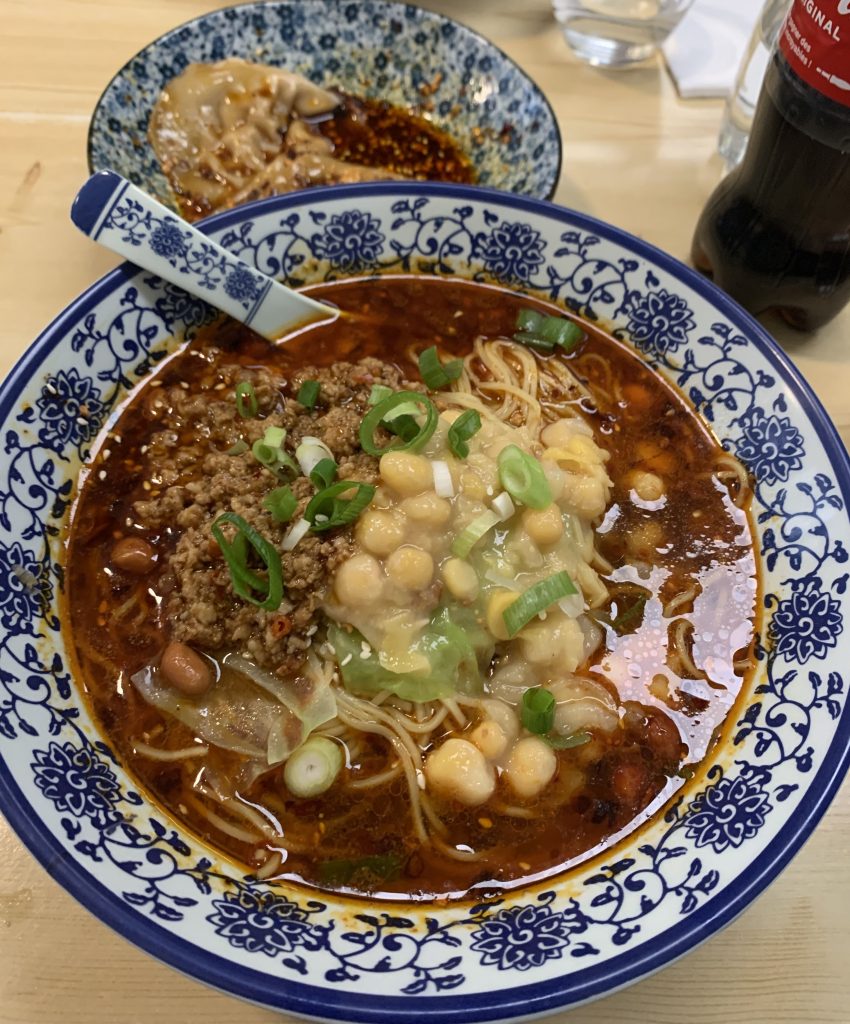 Bowl of soup and noodles with green onion