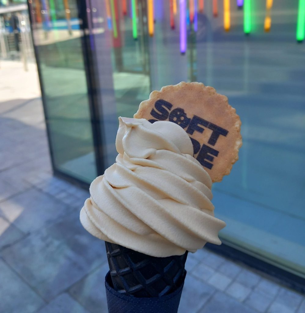 Black cone with white coloured soft serve ice cream