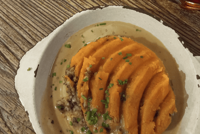 Plate of orange coloured haggis