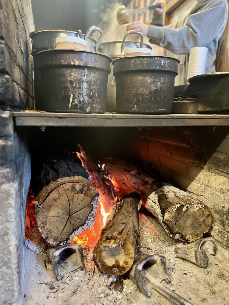 Pots and pans heated by burning logs beneath