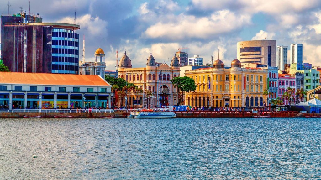Harbour with colourful buildings and spires in the background