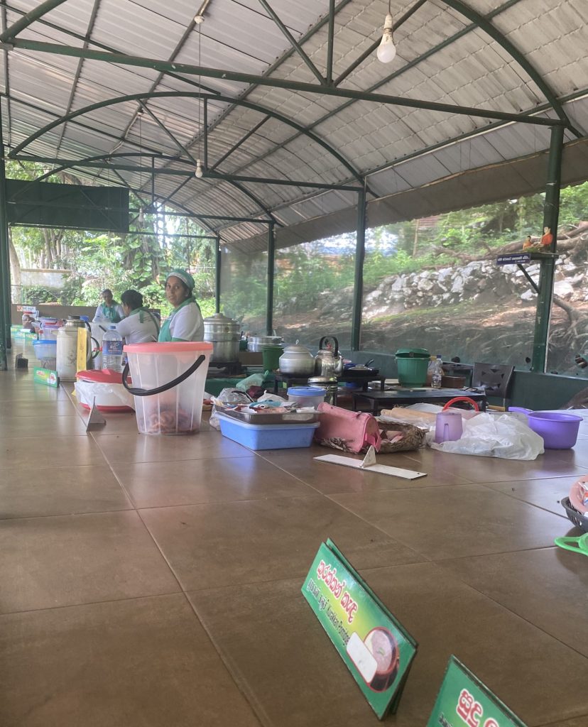 Women in covered stalls selling food