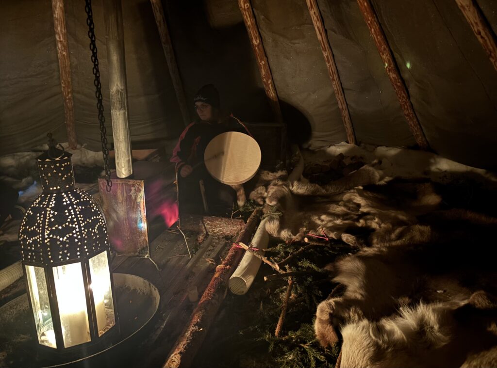 Woman with drum in tent