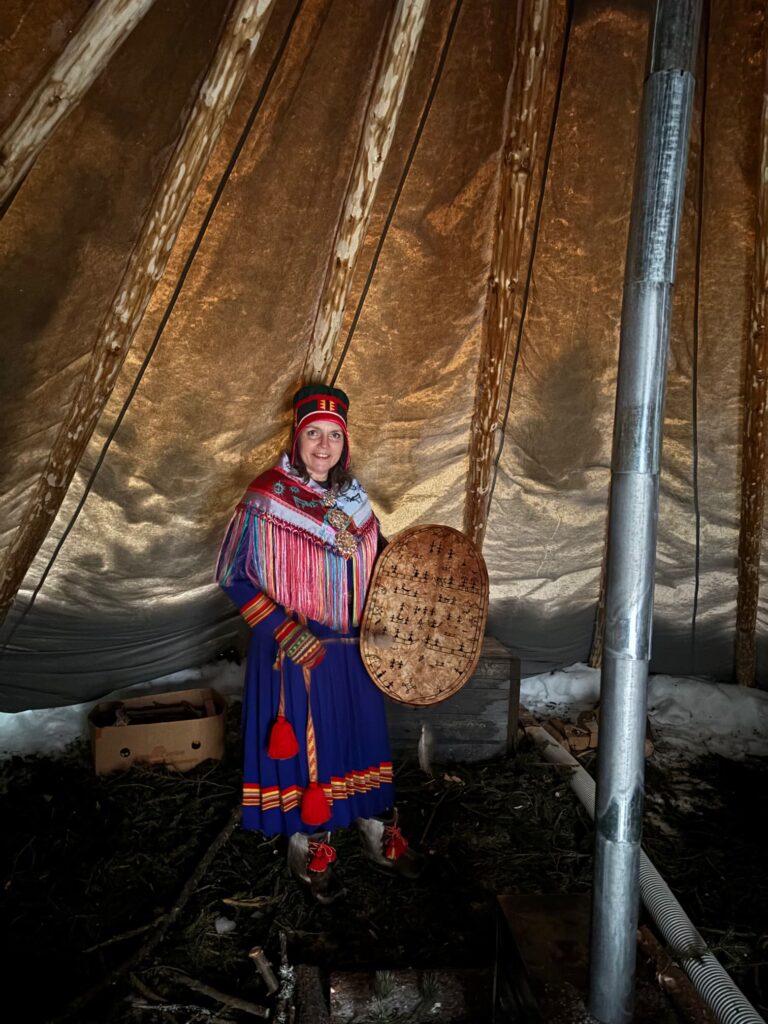 Woman in big tent posing in indigenous clothing