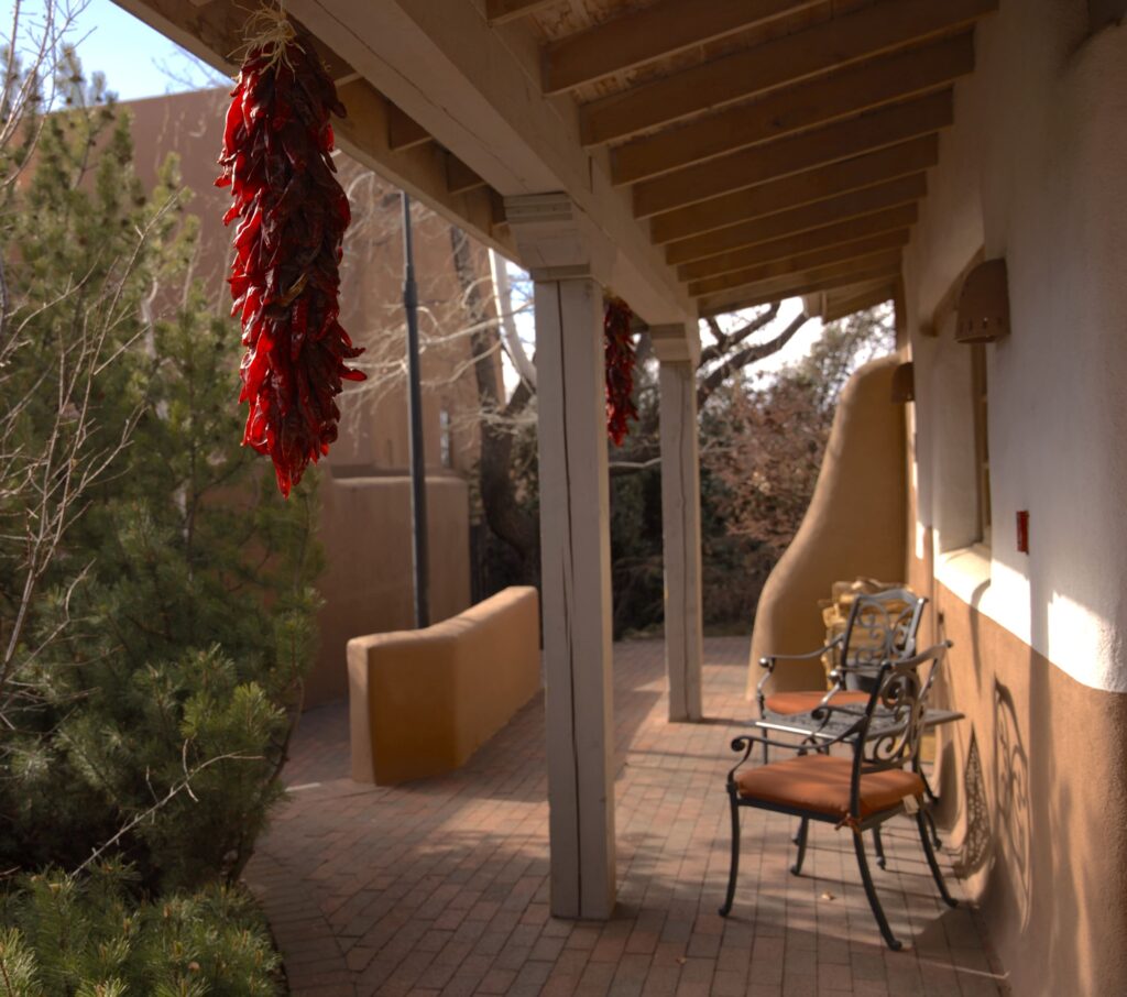 Patio deck with outdoor furniture and red chillies hanging from the ceiling