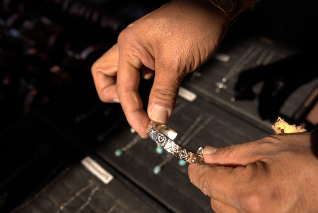 A pair of hands holding a bracet