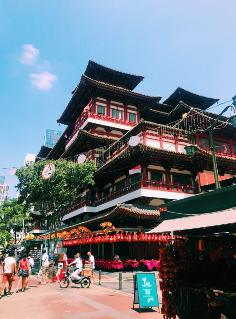 Multi story house in Chinese style architecture with people outside