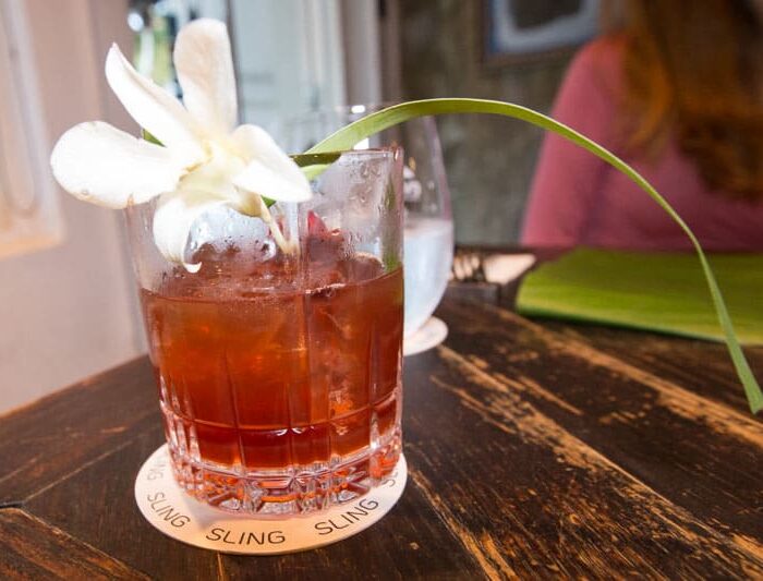 Cocktail glass with white flower and green lead sticking out