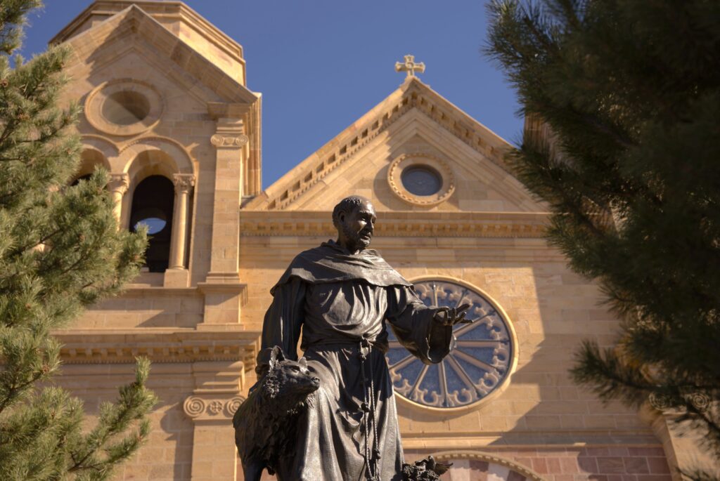 Statue of man in front of a cathedral