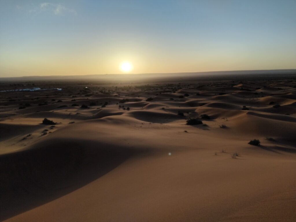 Sunrise over desert sand dunes