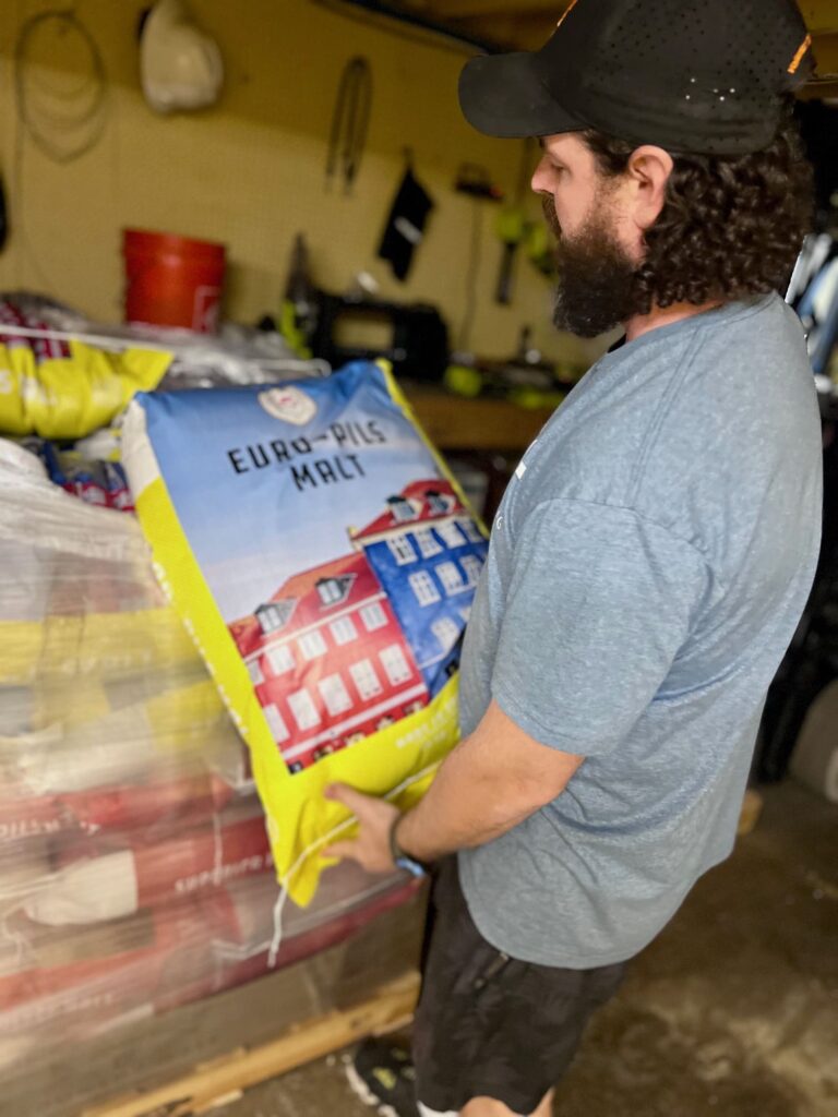 Man holding a bag of malt