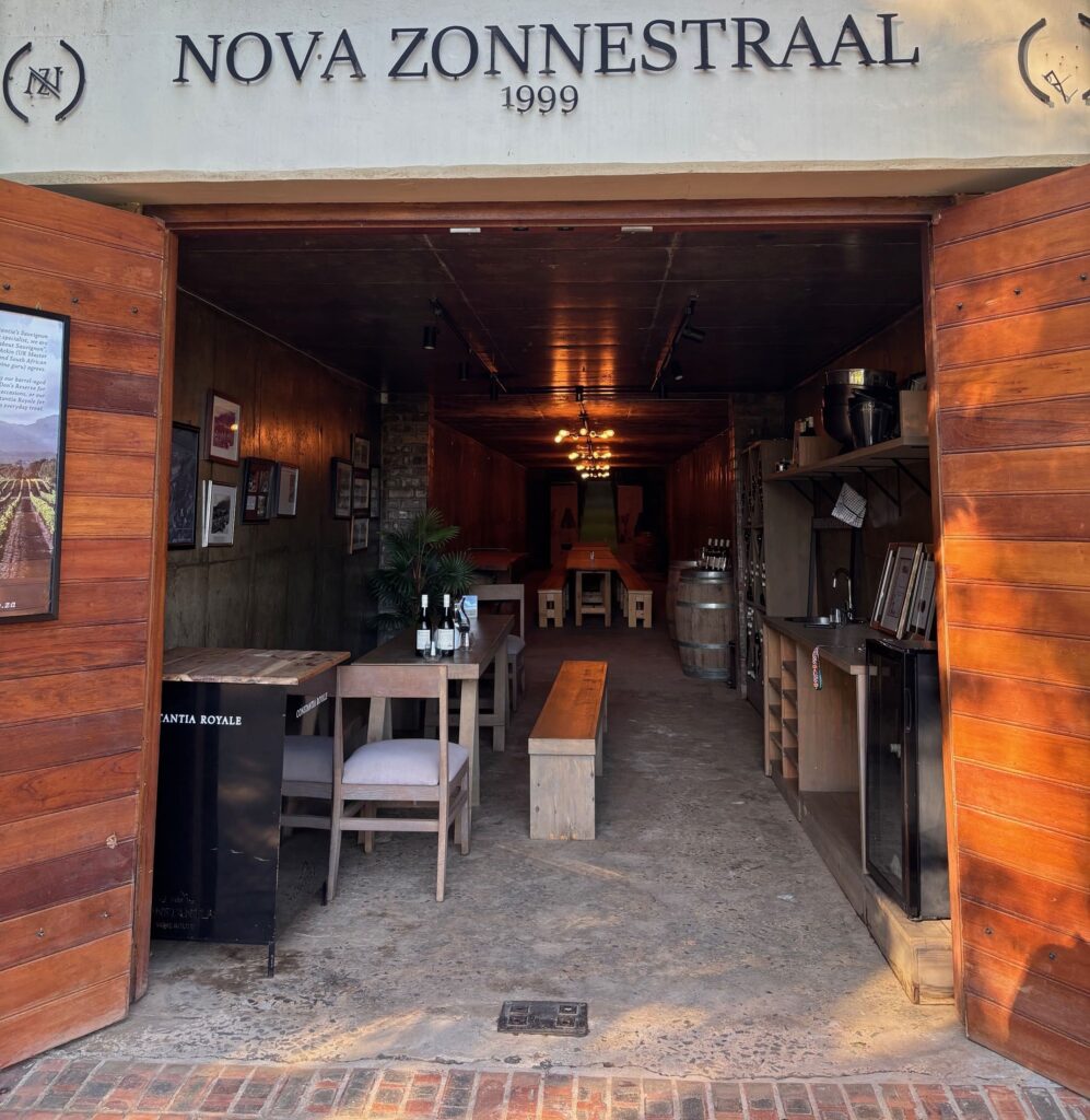 Entrance to wine tasting facility with chairs, benches, and tables