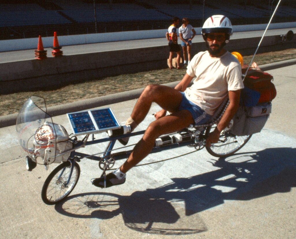Man on special constructed bike in seated position.