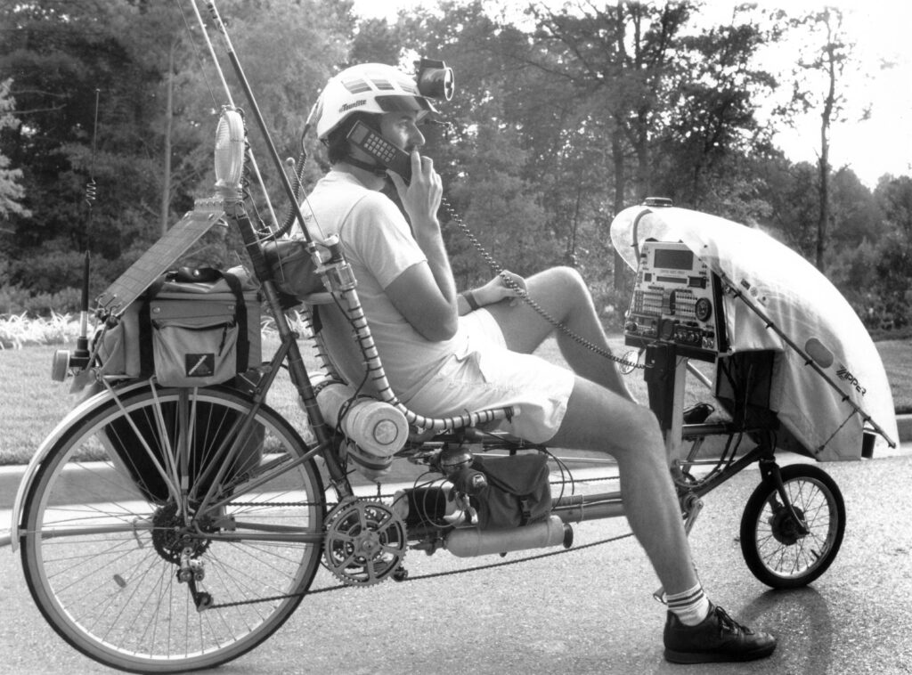 Man on bike talking on cellular phone connected to an onboard computer
