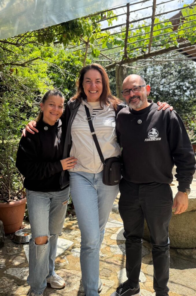 Two women and a man posing together