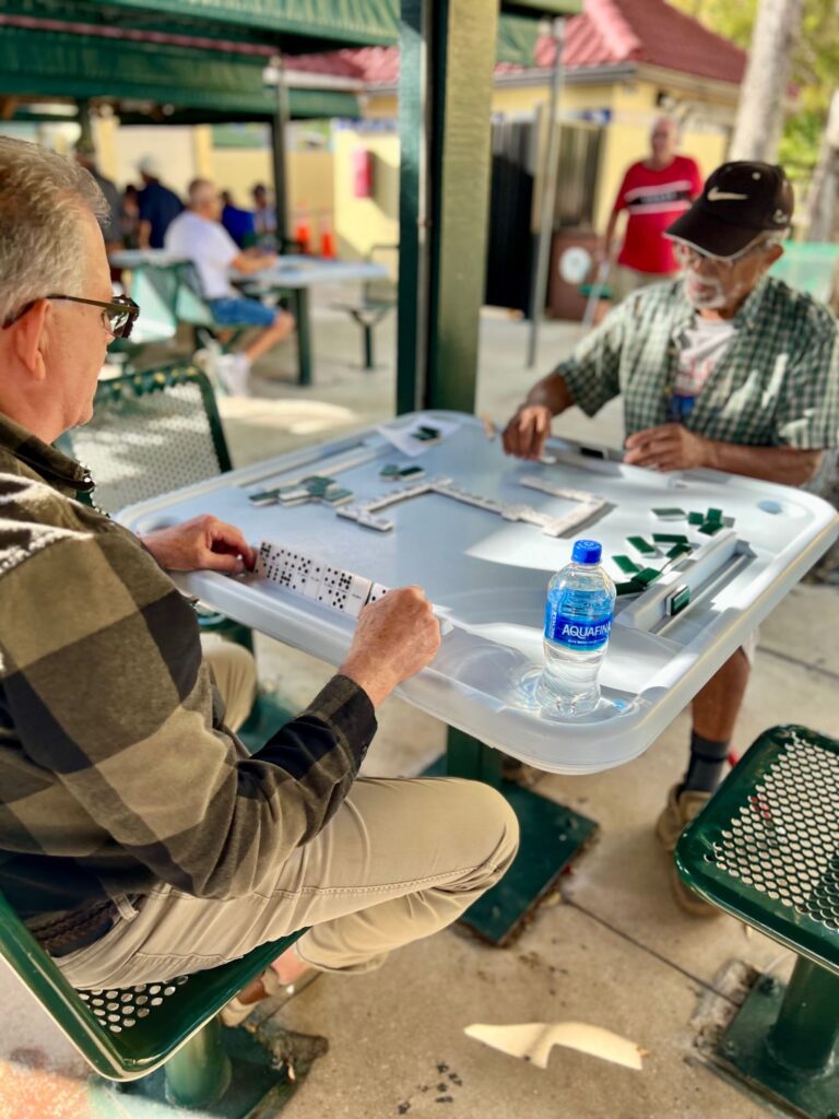 Two men playing dominoes in communal space