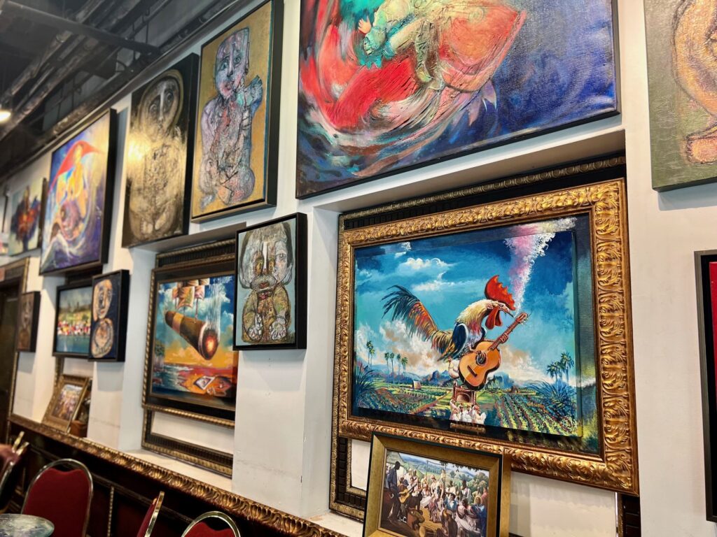 Museum wall filled with paintings
