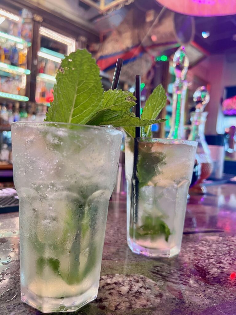 Two glasses of mojitos in a bar
