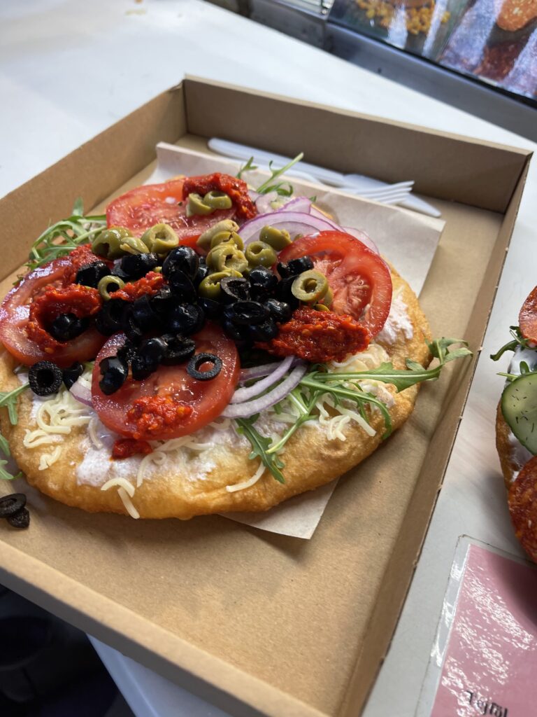 Langos (fried bread with tomato, olives, and toppings)