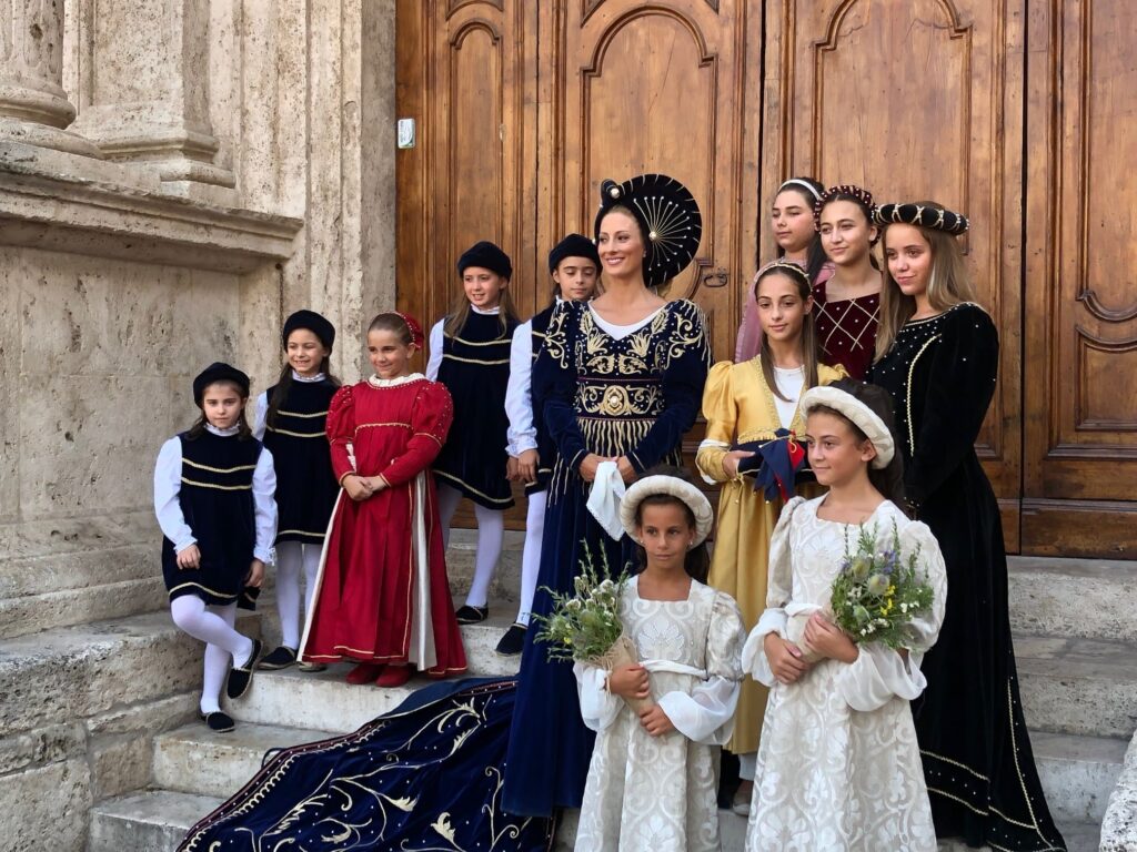 Group of children and and adult in costumes outside a church