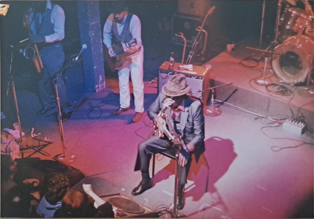 Man performing with guitar on stage