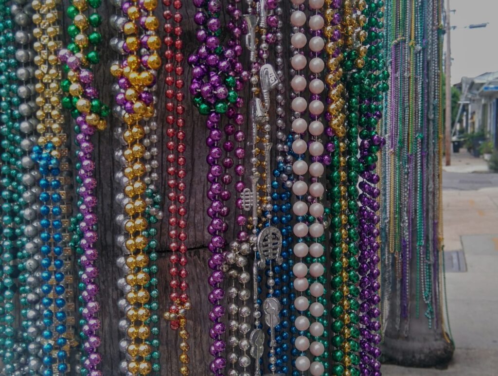 Pearl necklaces in different colours hanging on a stand