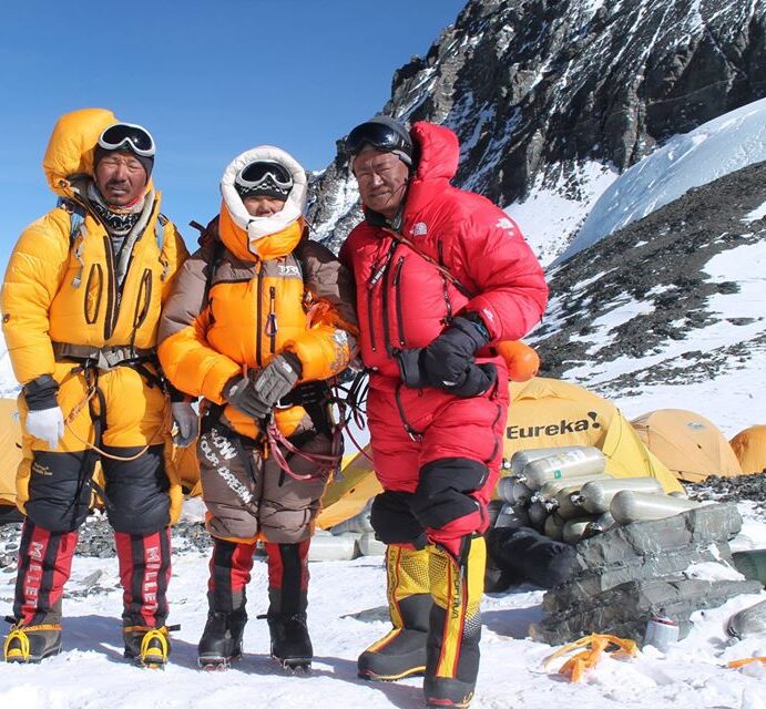 3 Sherpas standing at camp site in mountains