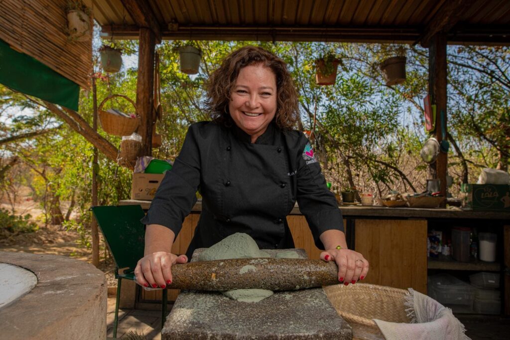 Woman with rolling pin posing in outside kitchen