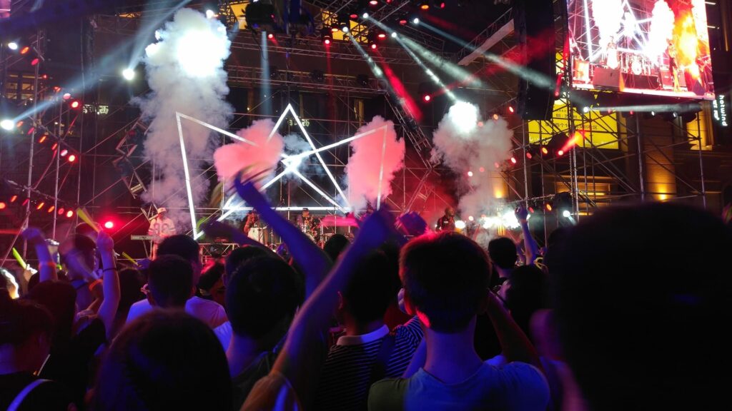 People celebrating at festival with lighshows