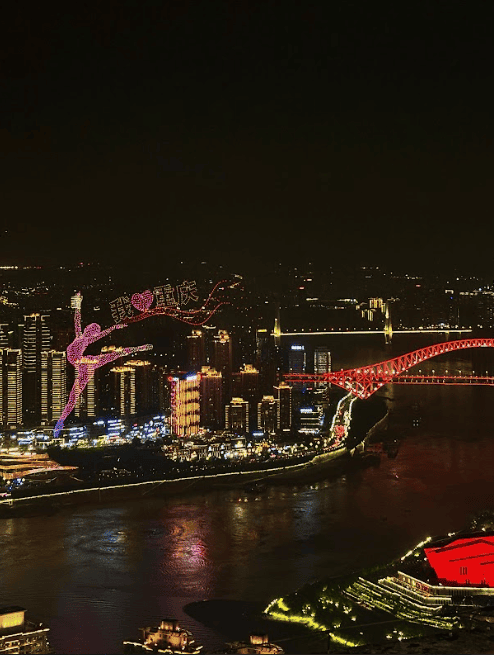 Lightshow with drones over lit city by a river