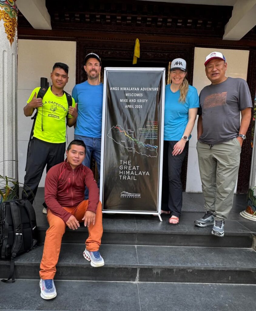 5 people posing with a promotional poster