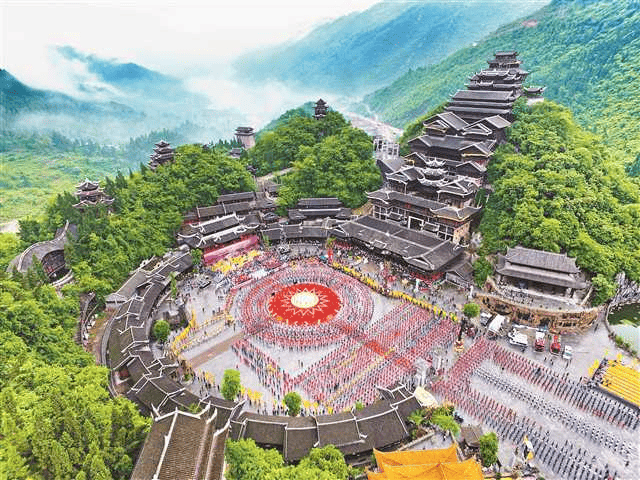 Buildings built around a circle with one section going over a ridge.