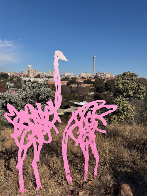 Installations of pink ostriches in park