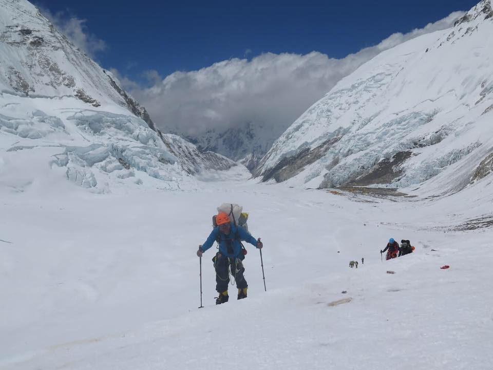 Man leading other climbers up a snow covered mountain