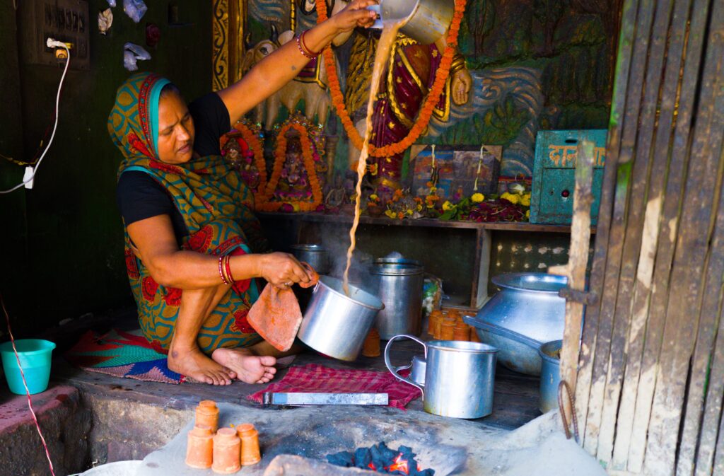 Woman sitting on floor making chai