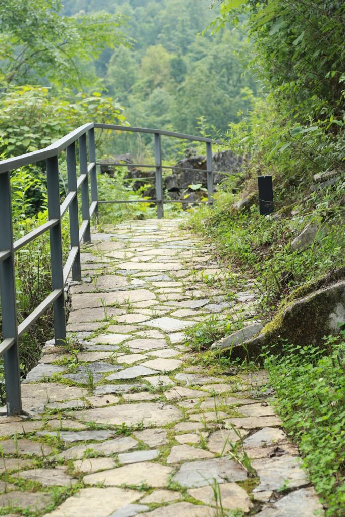 stone covered trail with security railing in nature