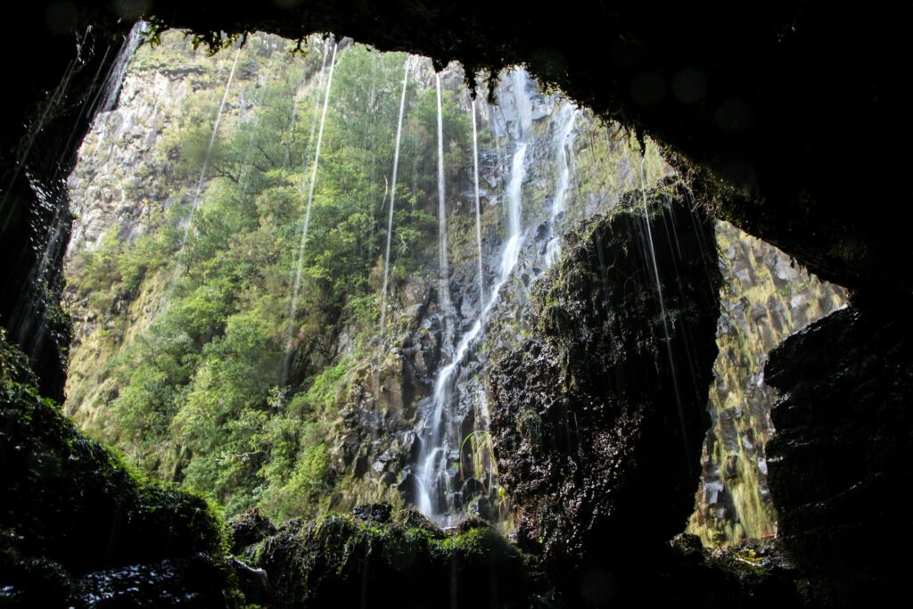 View of waterfall inside a cave